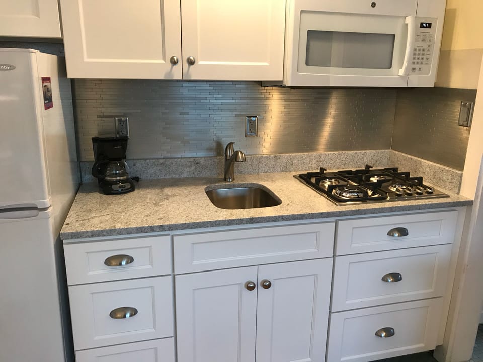 New cabinets, granite counter, high-end gas cooktop and microwave.
