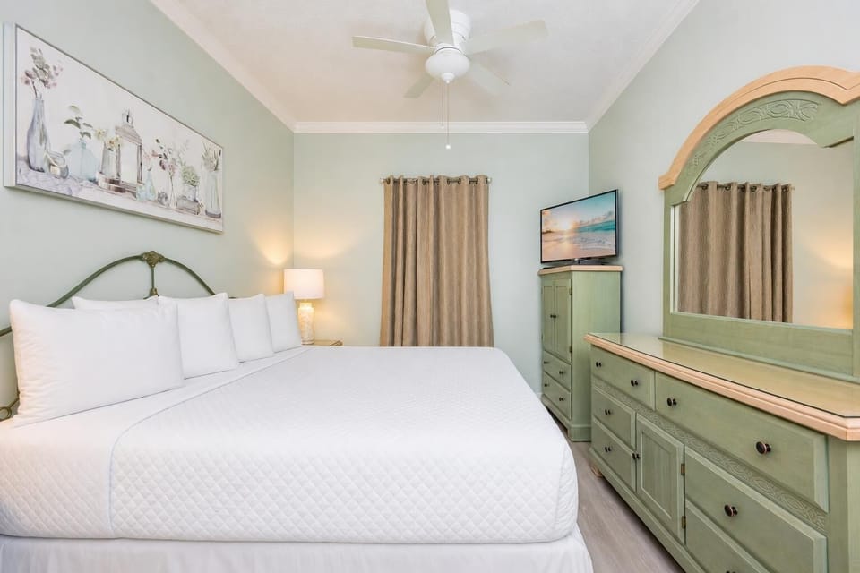 Plush pillows line the king bed in the suite where you unwind and watch evening shows on TV