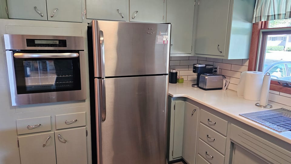 Appliances include a stand alone stove, cooktop, dishwasher, and fridge.