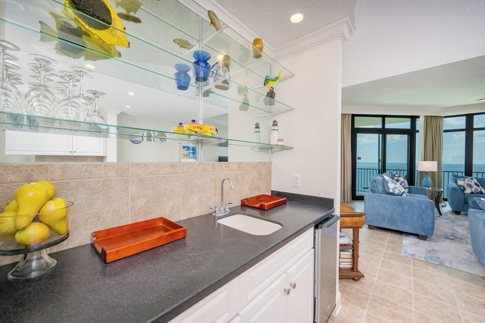 Mix refreshing drinks at your wet bar, surrounded by vibrant decor, as you unwind in this beach vibe setting
