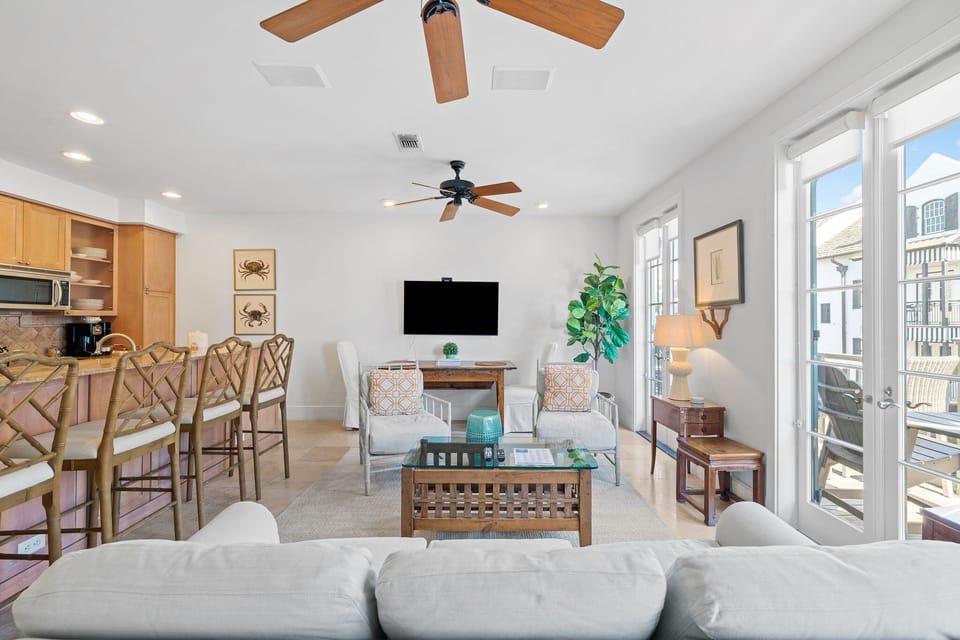 The lower level Features an open living-kitchen-dining area with access to the front staircase to Main St, a queen guest bedroom with full bathroom, and a built in twin bunk alcove in the living room.