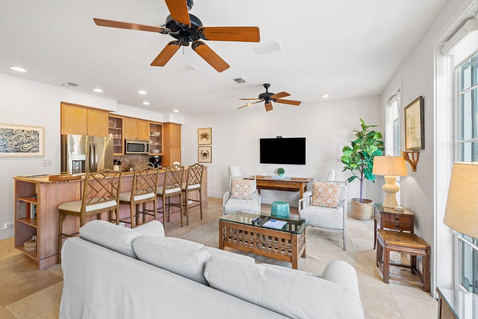 The lower level Features an open living-kitchen-dining area with access to the front staircase to Main St, a queen guest bedroom with full bathroom, and a built in twin bunk alcove in the living room.