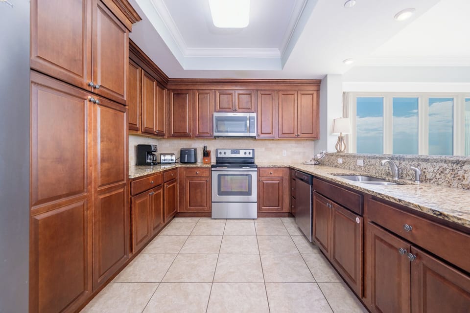 Sunlight reflects off granite counters as you prepare fresh meals in the bright kitchen space