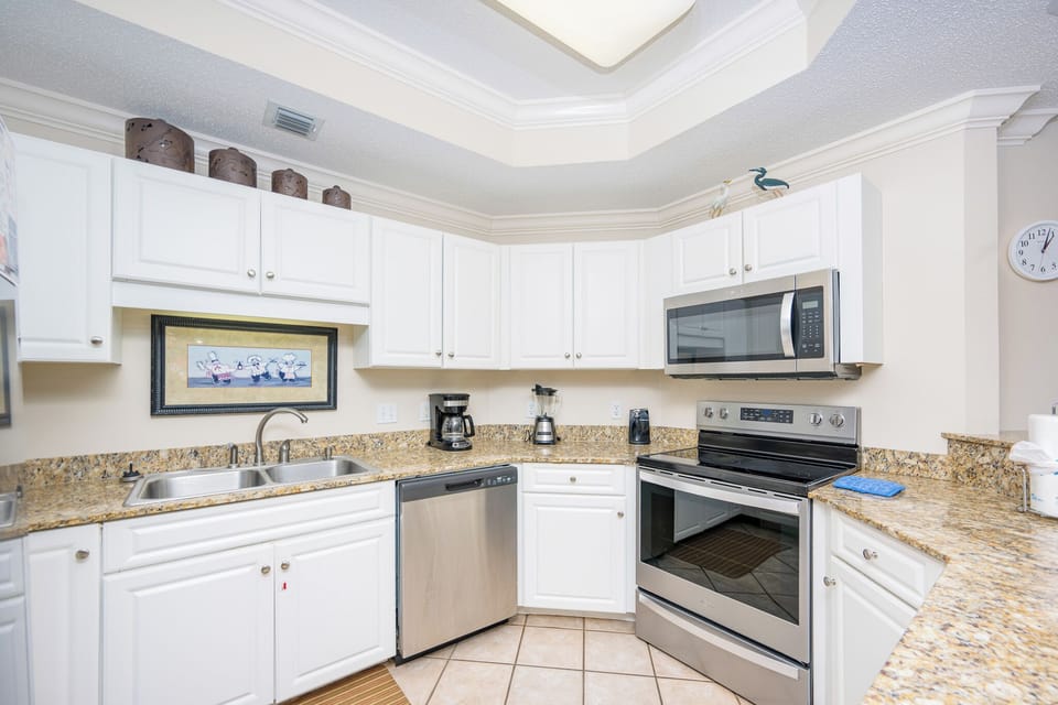 Prepare meals in this kitchen with sleek cabinetry, stainless appliances, and spacious countertops