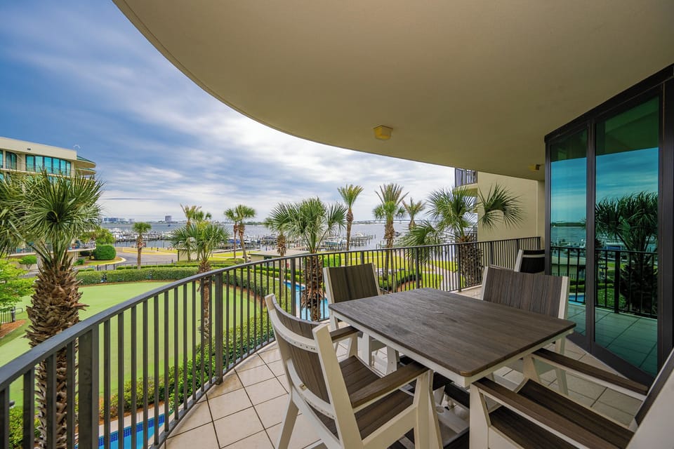 Breathe in the coastal air while lounging on the balcony, surrounded by palms and vibrant views of the bay