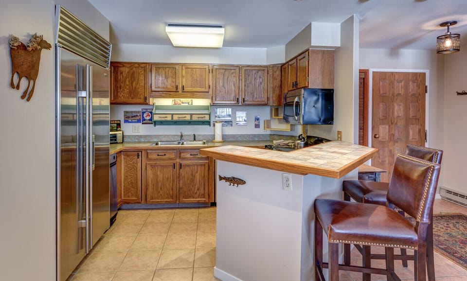 Kitchen with a refrigerator and chairs in our vacation condo in Steamboat Springs