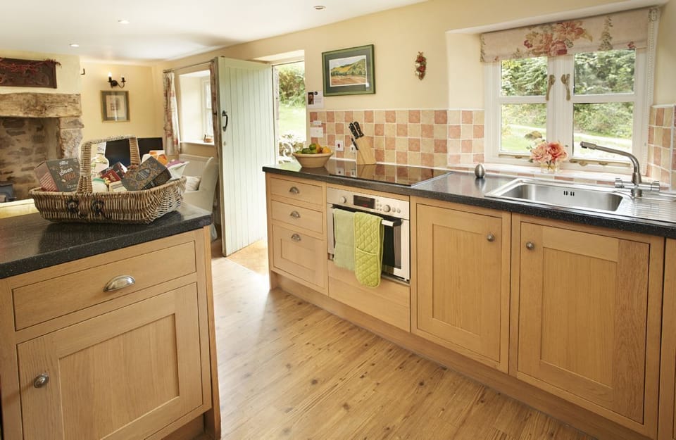 Ground floor: Open-plan kitchen, sitting and dining areas with french doors onto the patio