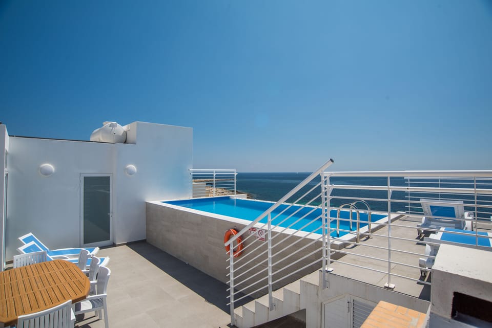 Outdoor Relaxation area with table, chairs, sun loungers and barbecue  