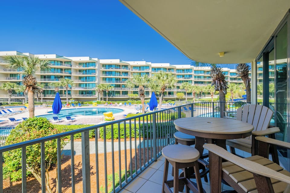 Breathe in the fresh air while savoring views of the sparkling pool and lazy rover from your inviting balcony