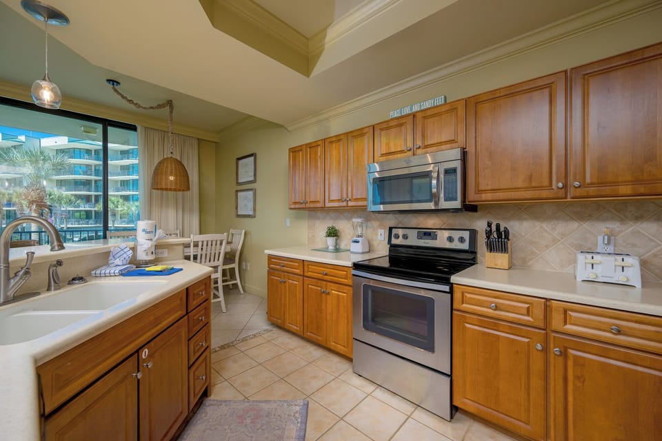 Prepare meals in this kitchen with elegant cabinetry, stainless appliances, and spacious countertops