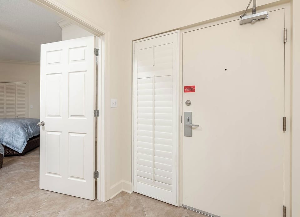 Step into a welcoming entryway featuring tiled floors and access to a cozy bedroom just beyond the door