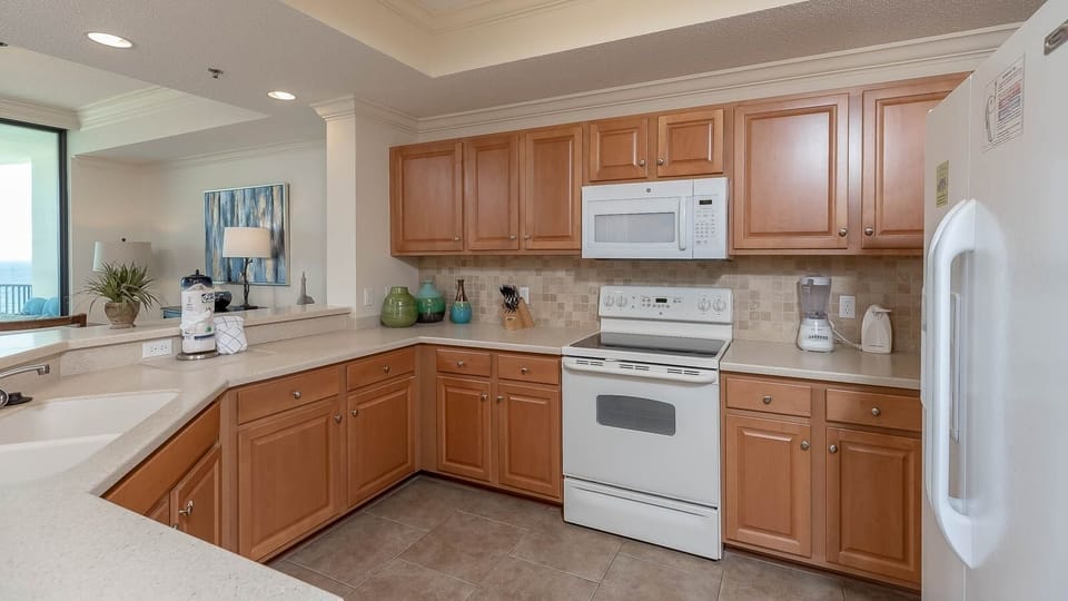 Cook with ease in this spacious kitchen featuring white appliances and an open-design, perfect for meal prep