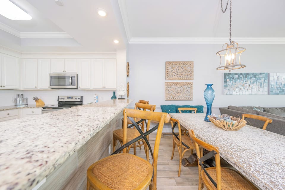 Spend time around the spacious dining table, enjoying meals with friends while surrounded by coastal decor