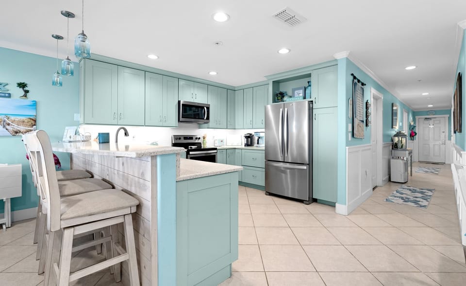 Kitchen Island — Mint Cabinets, Weathered-Wood Bar with Stools & Hallway View