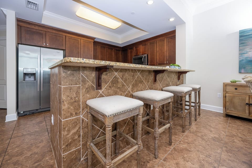 Gather around the stylish bar area with comfortable stools, perfect for casual meals and conversations