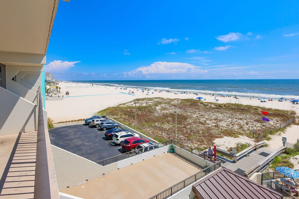 Enjoy stunning beachfront views from this inviting balcony, perfect for relaxation and soaking up the sun