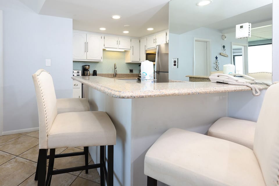 The kitchen features elegant cabinetry, a spacious countertop, and modern appliances, perfect for meal prep