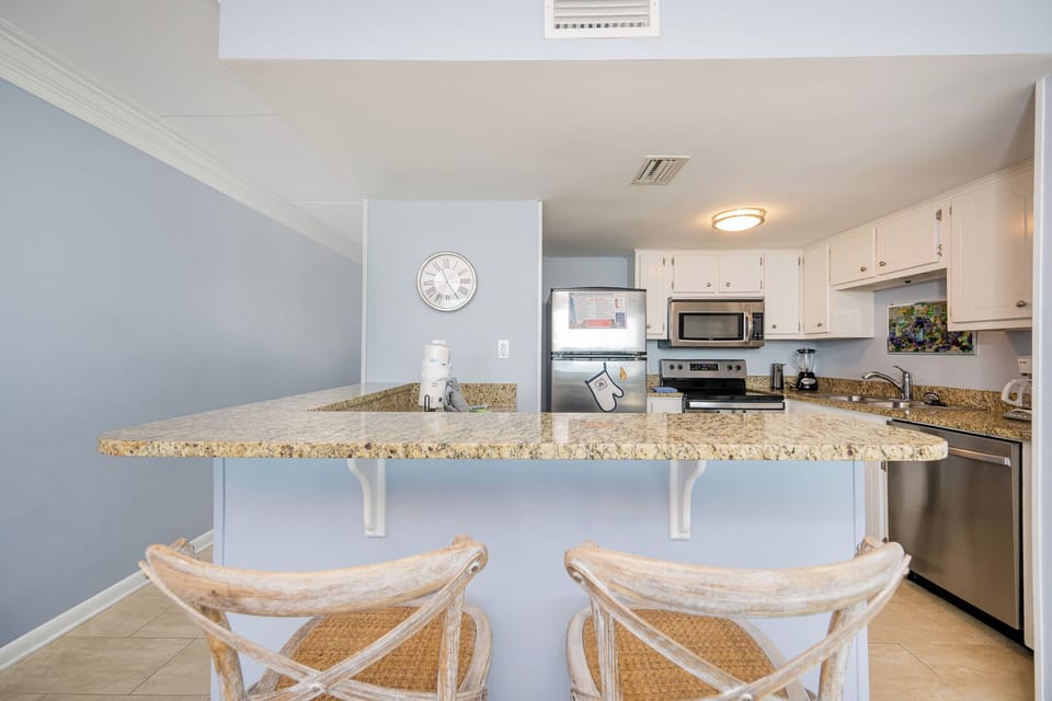 Gather at the breakfast bar, where you can chat and enjoy snacks while soaking in the relaxed beach vibe