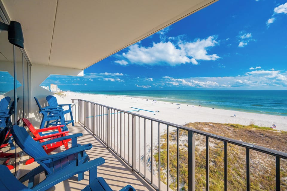 Relax in vibrant chairs as you savor the scenic coastal views and refreshing breezes from your balcony