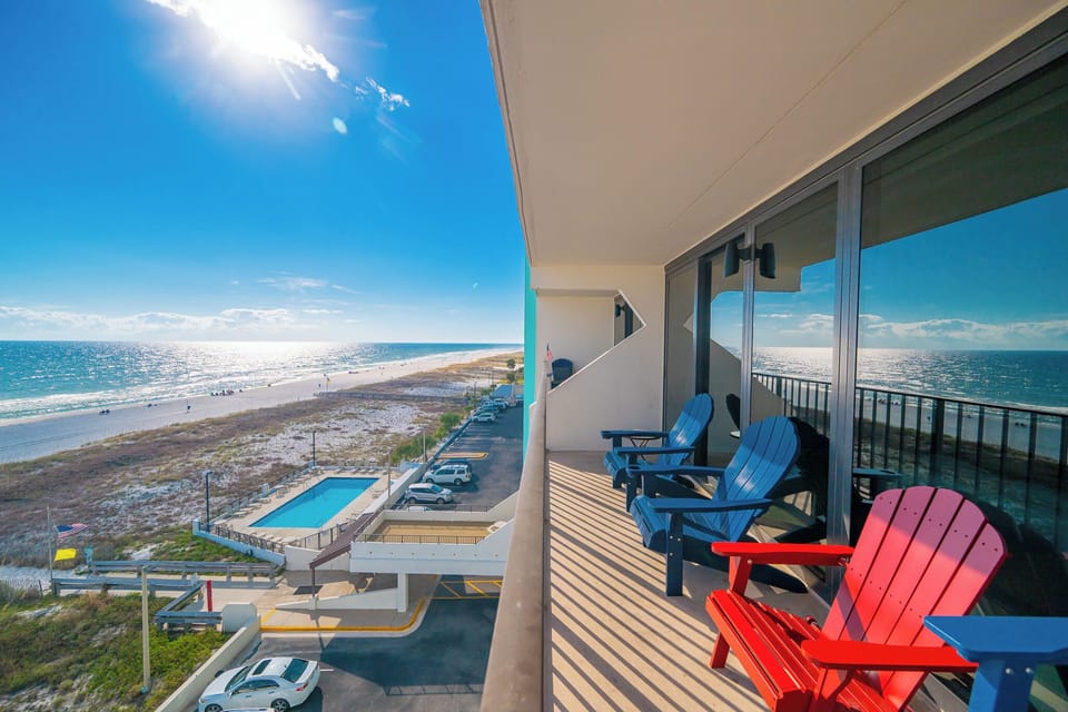 Soak up the sun from your balcony, relaxing in vibrant chairs as you feel the beach vibe