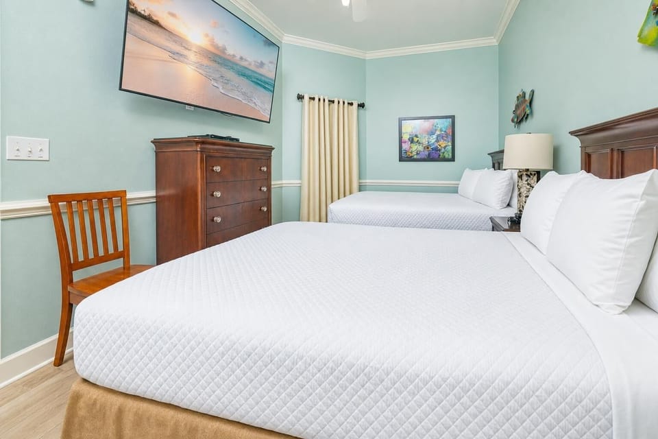 Experience restful moments in this guest bedroom, where two double beds await as you plan your beach adventures