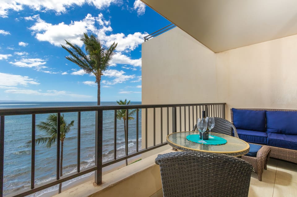 Your private balcony frames stunning ocean views, where swaying palms and endless blue skies invite you to sip wine and unwind in coastal serenity.
