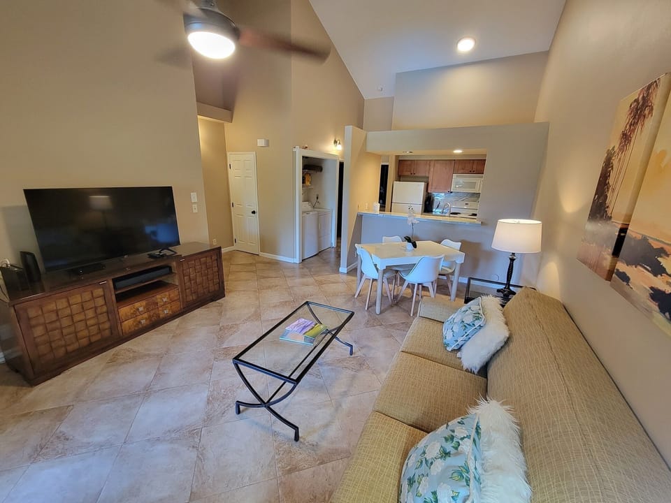 Living area with entertainment, dining, and kitchen