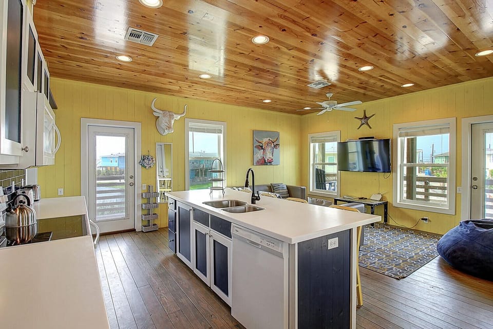 Your spacious open-concept kitchen features rustic wood ceilings, modern appliances, and plenty of natural light for memorable meal prep.