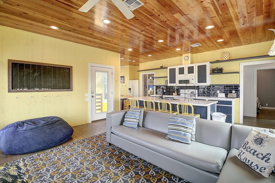 Relax on plush sofas under stunning wood ceilings while your family gathers around the open kitchen island.