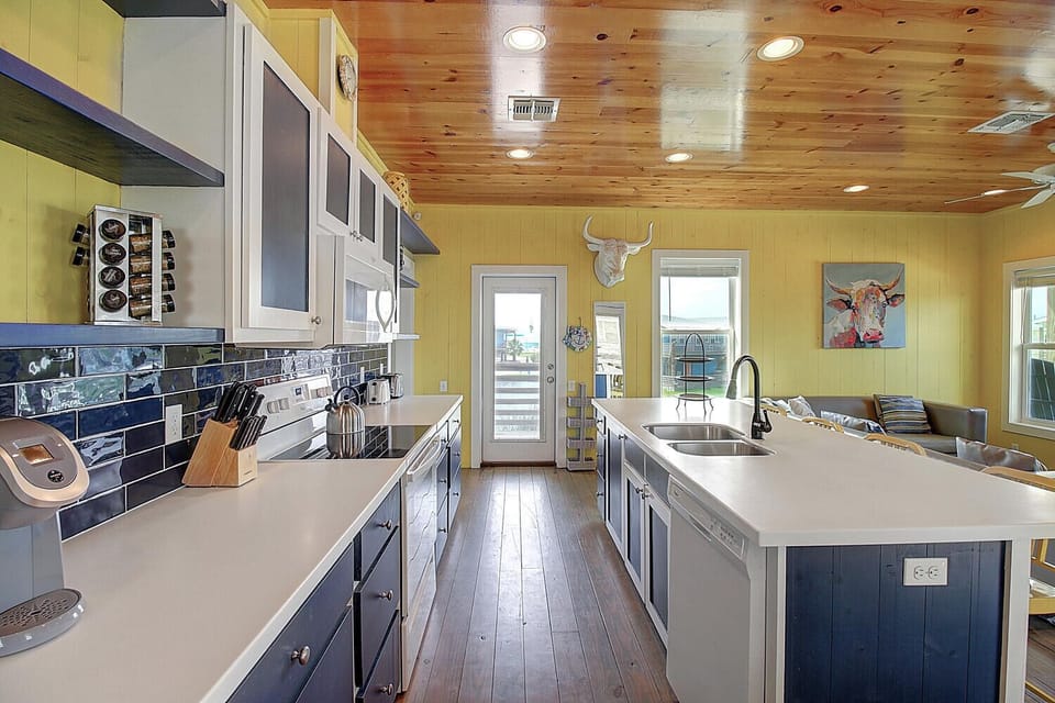 Cook with rustic charm in this spacious galley kitchen featuring custom cabinets, modern appliances, and warm wood details.