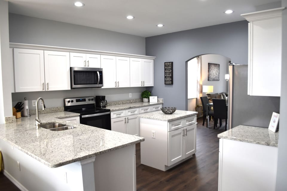 Fully equipped kitchen with island and granite countertops.