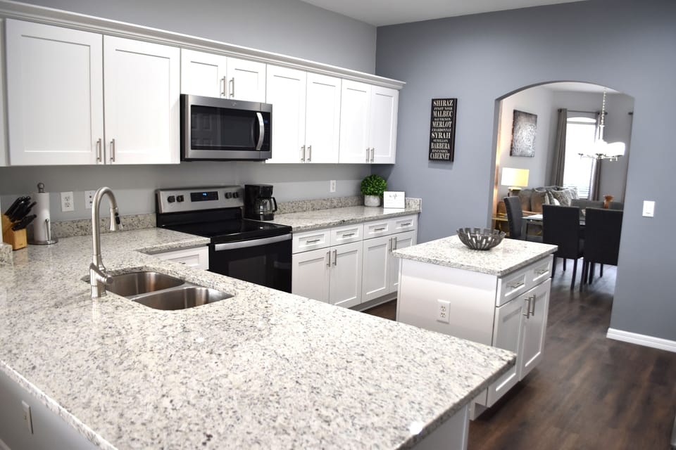 Fully equipped kitchen with granite countertops and center island.