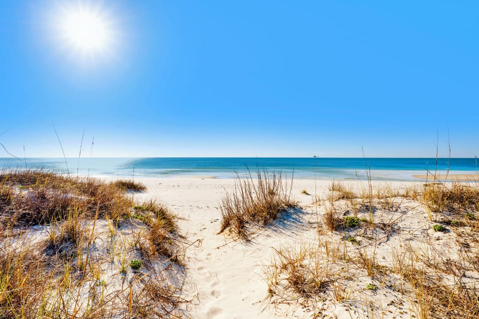 A beachfront home located in the secluded Fort Morgan peninsula