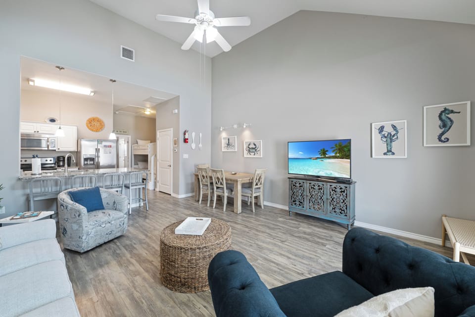 Settle into your coastal-themed living space where ocean-inspired artwork and nautical decor create the perfect backdrop for relaxing evenings.