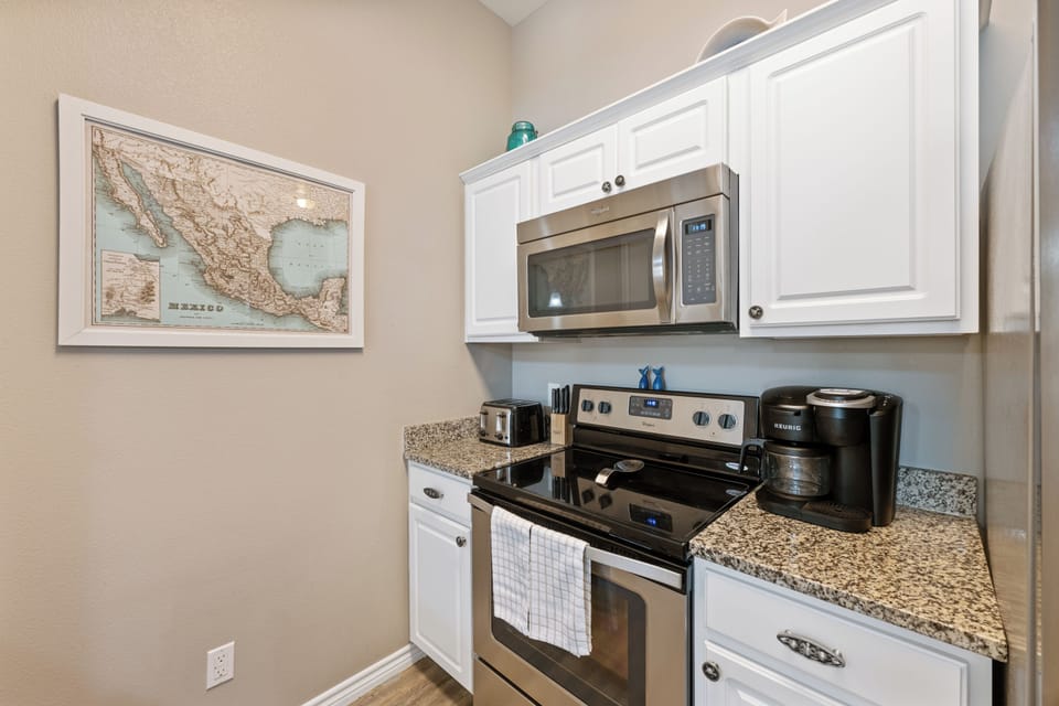 Your fully equipped kitchen awaits with granite counters, stainless appliances, and everything you need to create memorable meals together.