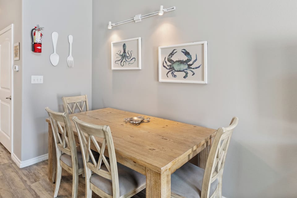 Gather around your rustic dining table for memorable meals with coastal charm surrounding you.