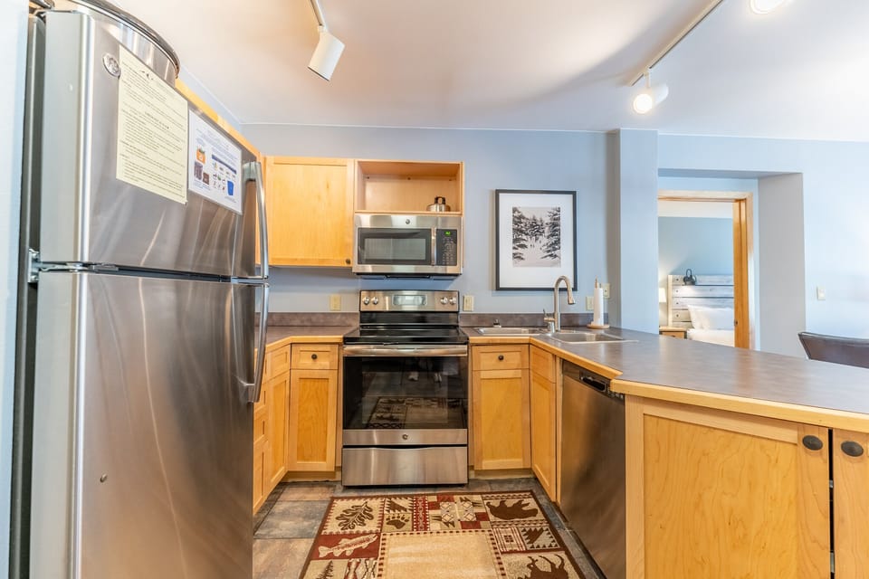 Cook comfortably in your modern kitchen with stainless appliances, warm wood cabinets, and spacious countertops—perfect for preparing meals during your stay.