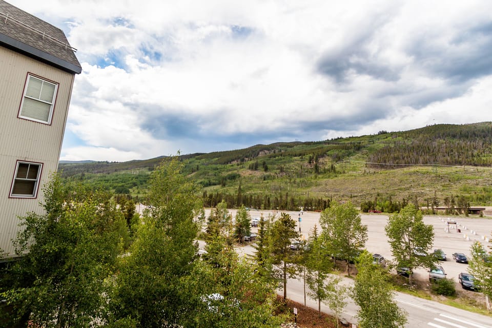Mountain views stretch across forested hills and valley landscape from this elevated perspective near the property.