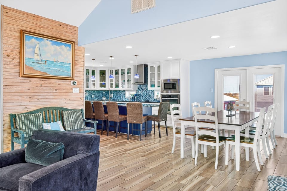 Unwind in this bright open-concept space where coastal charm meets modern comfort. Your gourmet kitchen flows into cozy living and dining areas.