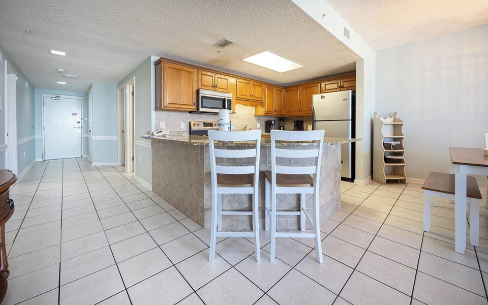 Gather around the breakfast bar or dining table, enjoying the open layout and easy access to the kitchen