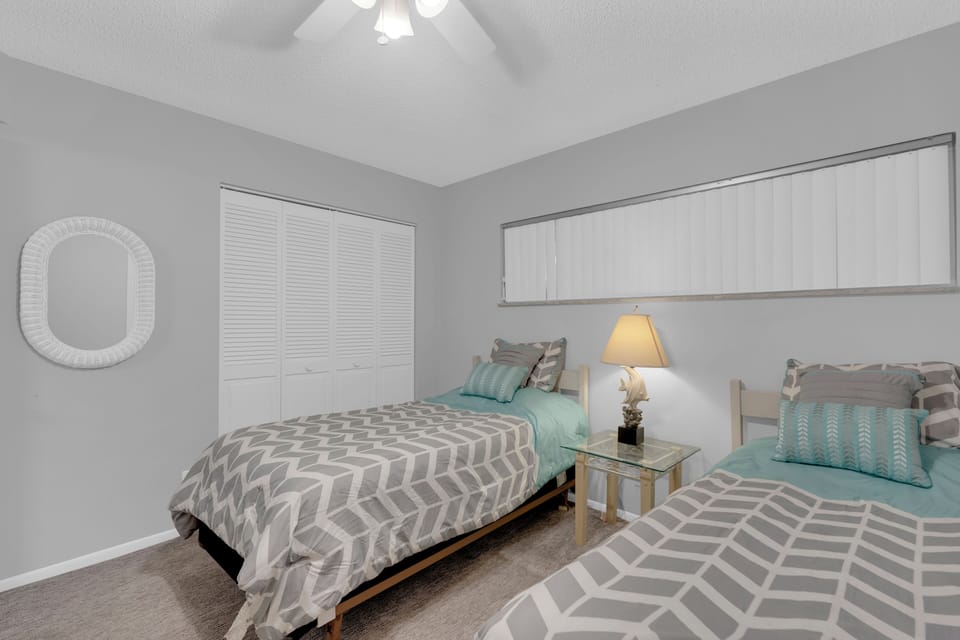 Twin beds in guest room at Sand Caper 407