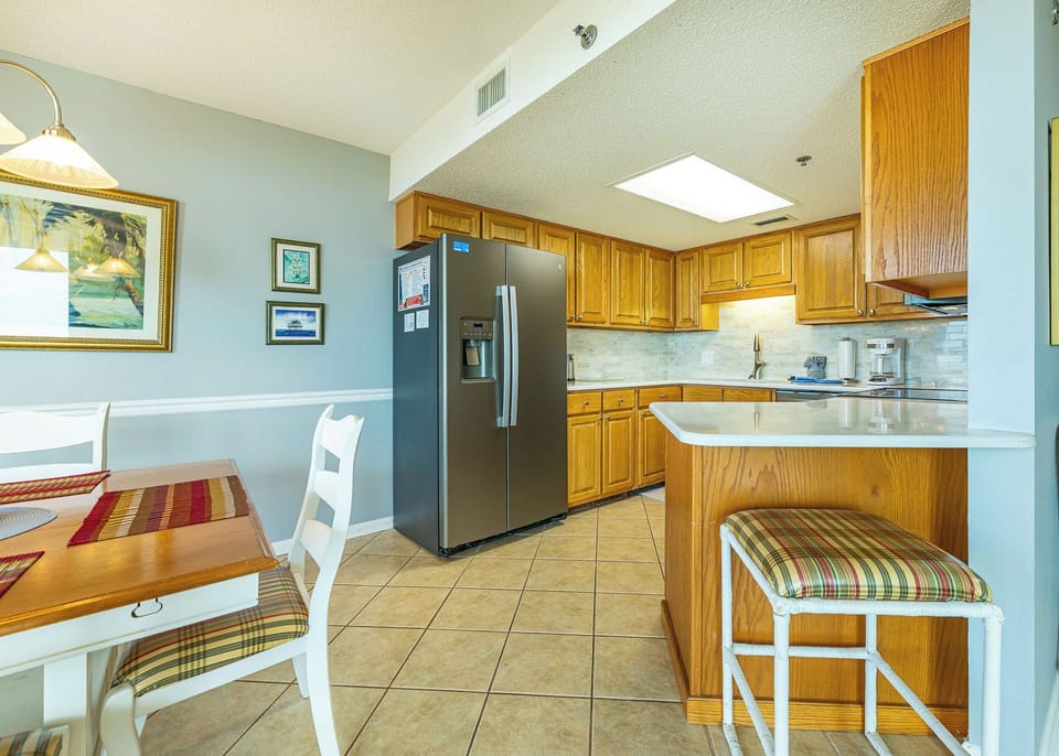 Warm wooden cabinets complement the sleek appliances in this inviting kitchen, ideal for preparing meals during your stay