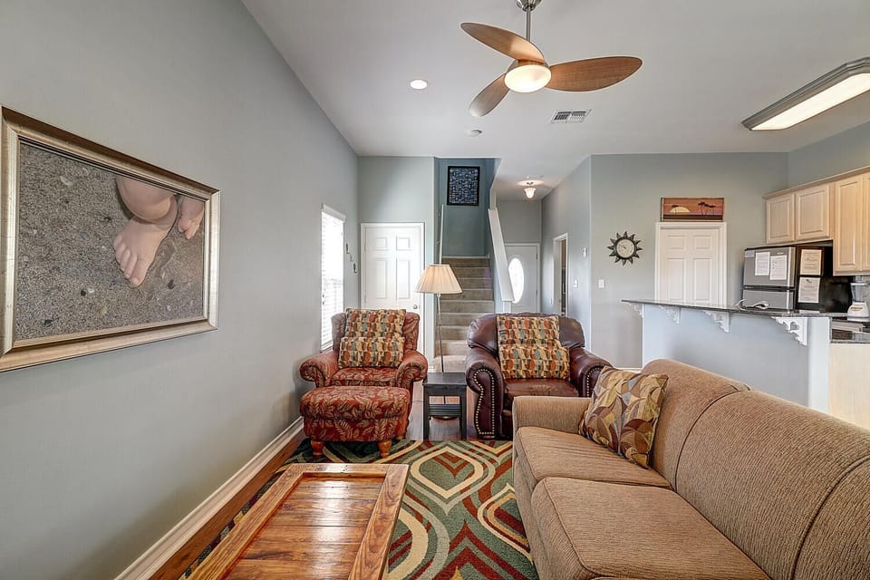 Unwind in your cozy living room with plush seating and coastal-inspired decor that creates the perfect retreat atmosphere.