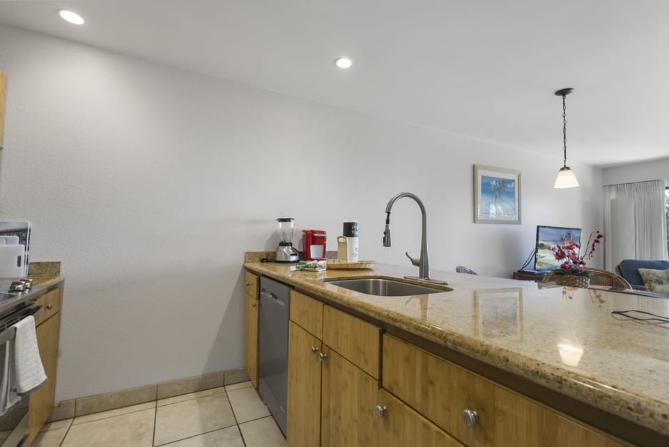 Your fully-equipped kitchen awaits with gleaming granite countertops, modern appliances, and an open layout that flows seamlessly into the bright living area—perfect for preparing meals and gathering together.