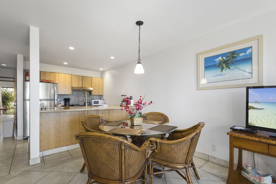 Your open-concept dining and kitchen space awaits, where coastal-inspired décor and modern conveniences set the stage for memorable meals together.
