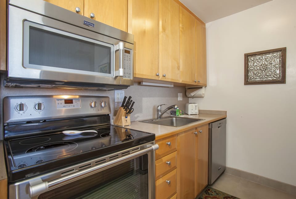 Your fully equipped kitchen features stainless steel appliances, warm wood cabinetry, and everything you need to prepare home-cooked meals during your stay.