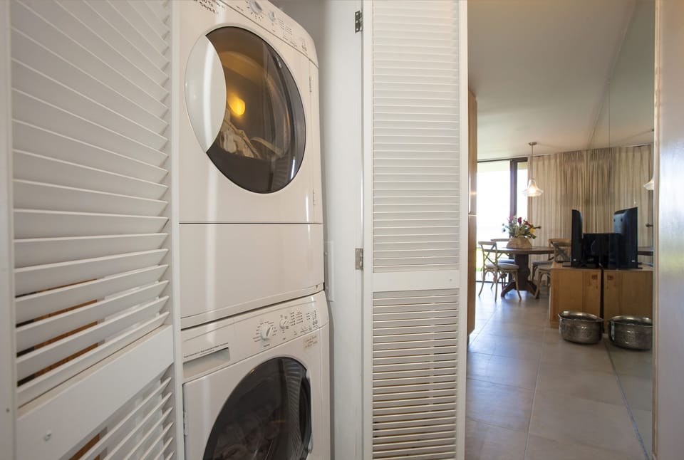 Your in-suite laundry is tucked neatly into the hallway, making it easy to refresh your wardrobe between beach days and local adventures.