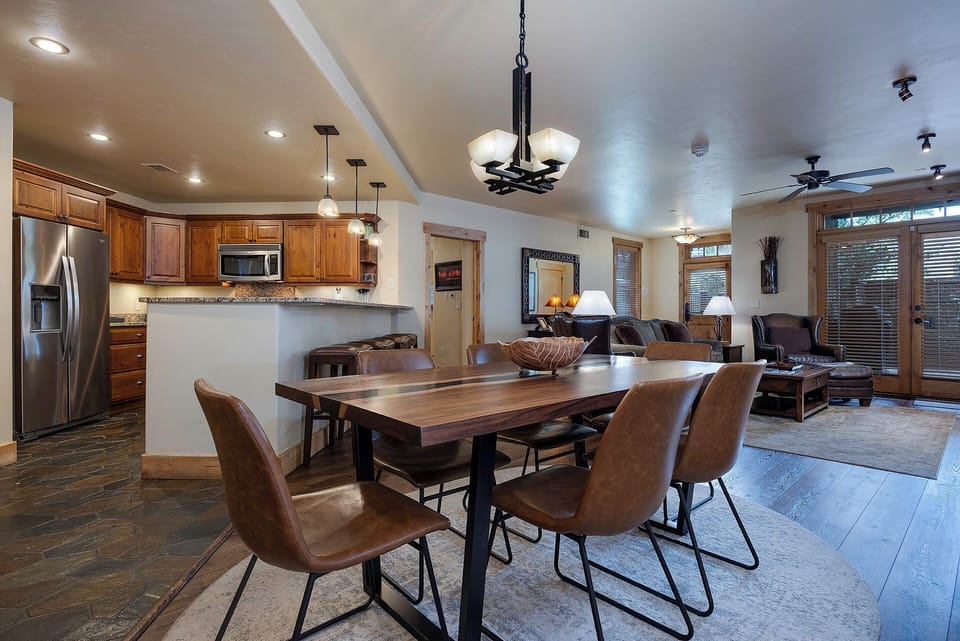 Gather around the handsome dining table, perfectly positioned between your open kitchen and cozy living area—where you'll cook, share meals, and unwind in effortless comfort.