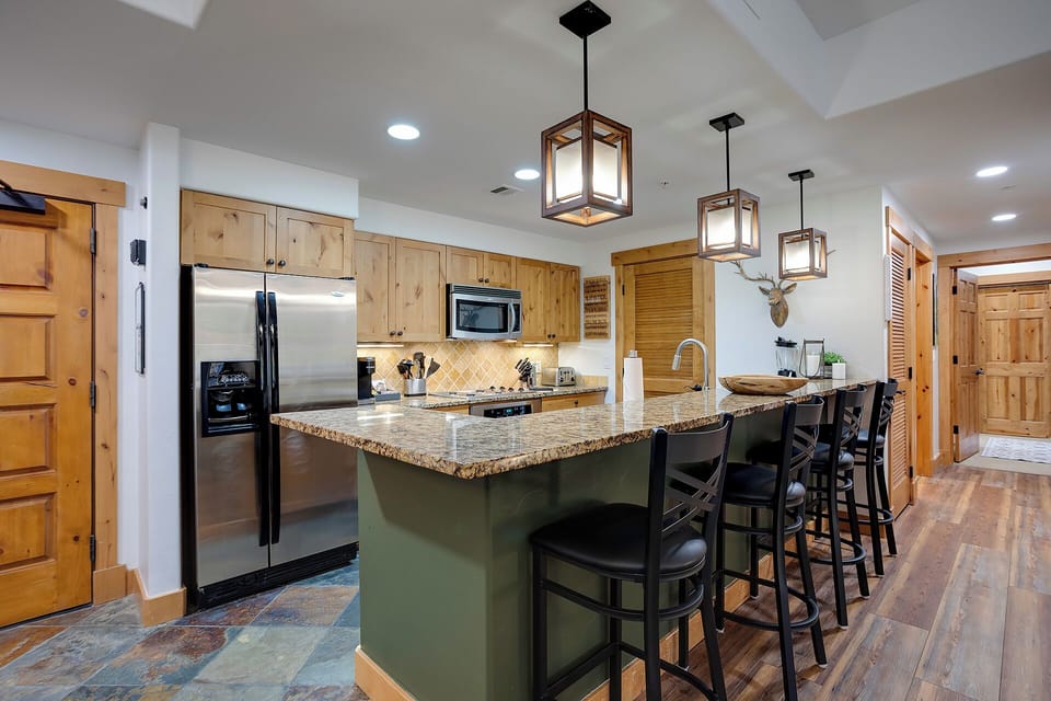 Your gourmet kitchen awaits with granite counters, stainless appliances, and island seating for memorable meals together.