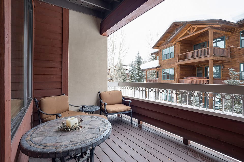 Cozy up with morning coffee on your private balcony, watching snow dust the mountain village below through rustic wooden railings.
